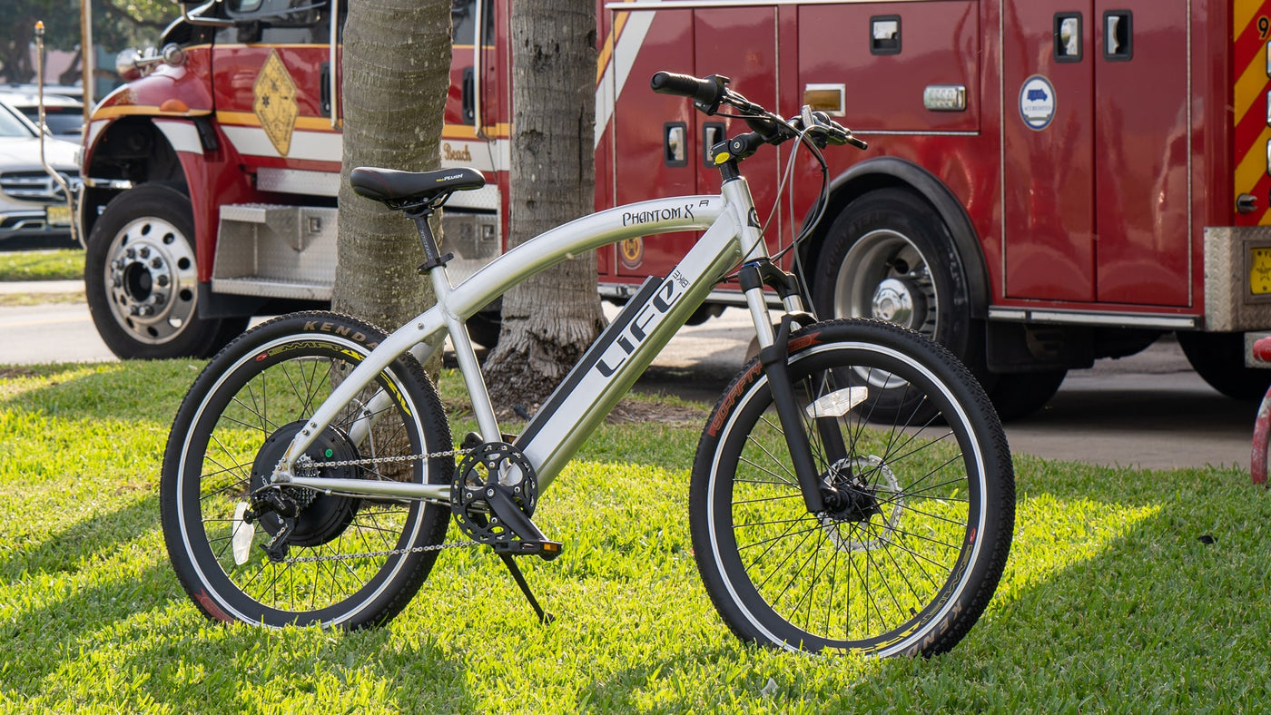 Phantom XR ebike is next to a fire truck. 